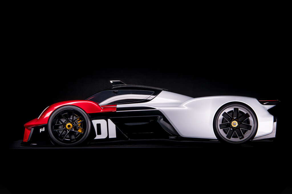 Porsche Vision 920 concept car shot at eye level of the driver side with the number 01 in white with yellow center caps on the wheels.