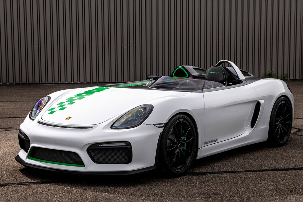 White Porsche Boxster Bergspyder with a green checkered stripe going down the right side of the hood.