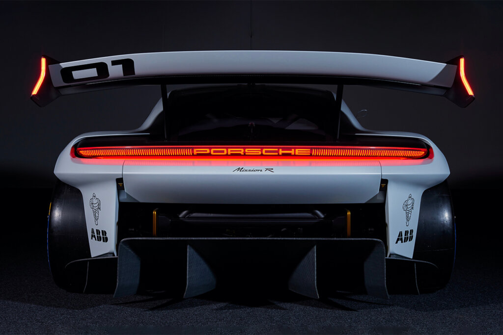 White Porsche concept car with large single rear taillight with a large rear mounted wing and diffuser.