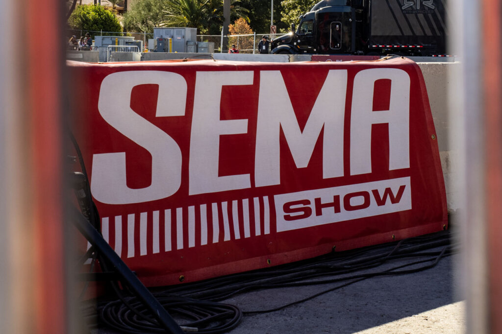 red SEMA 2024 banner on a k rail barrier