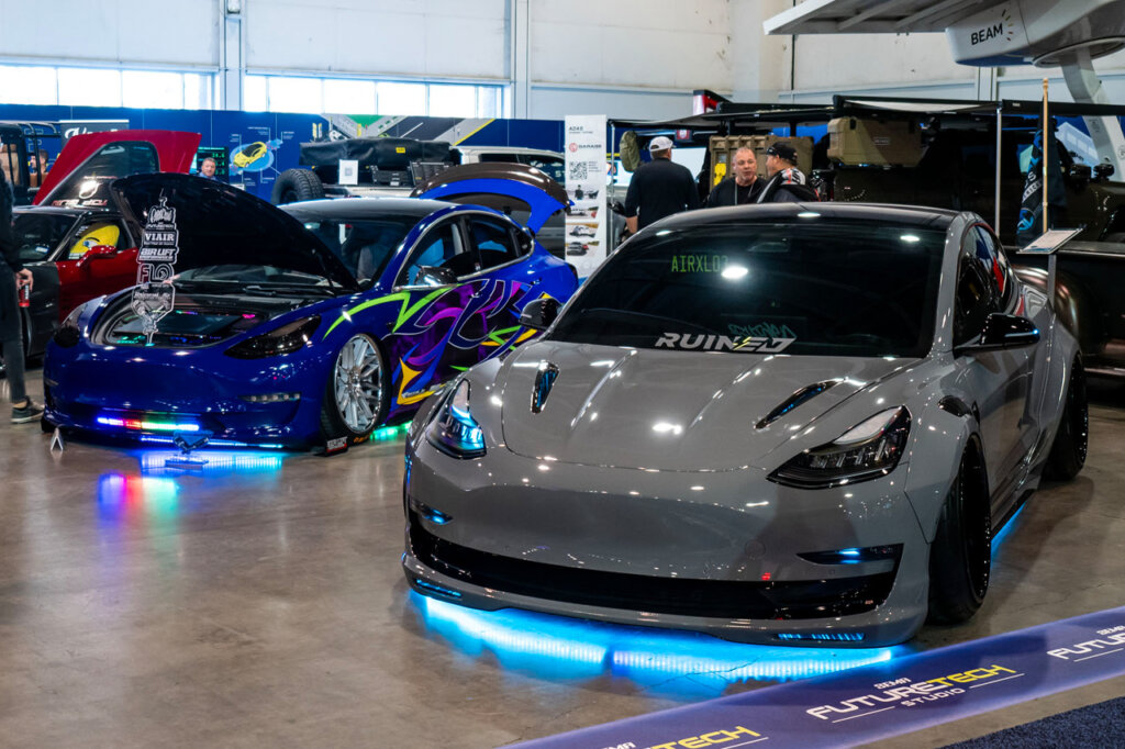 Gray Tesla model 3 with widebody and underglow lights at SEMA 2024