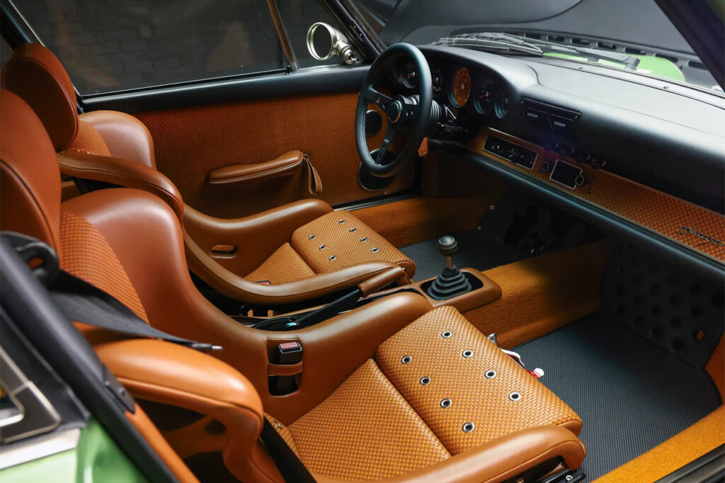 Custom orange leather interior of a green Singer Porsche 911.