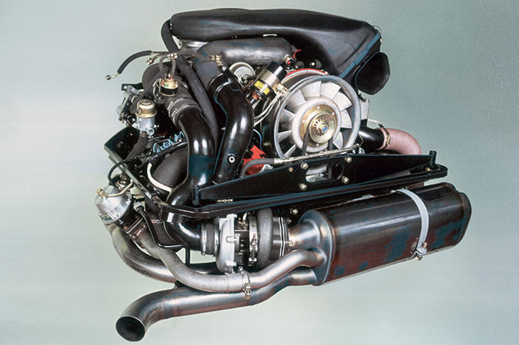 911 930 3.3L flat six Turbo engine outside of a car pictured on a gradient background.