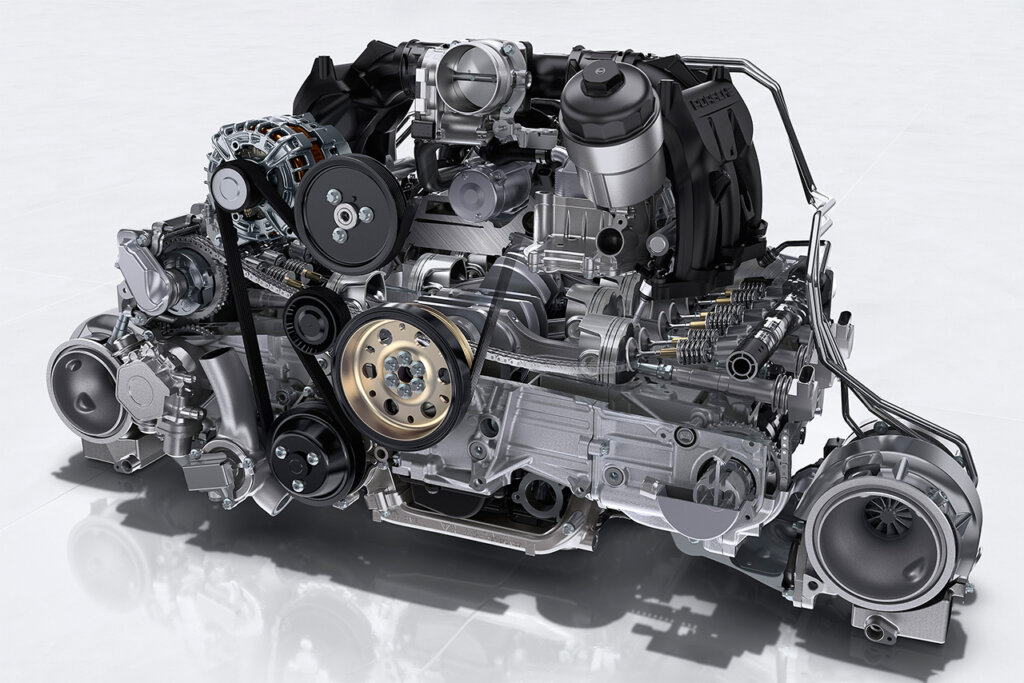 twin turbo boxer engine setup for a 911 GT2 RS pictured on a white background.