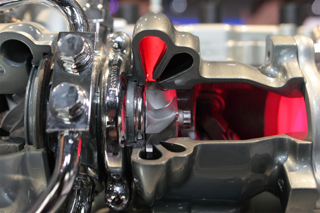 Exposed Turbo housing with a red light showing where exhaust fumes direct the internal fan to spin compressing the air.