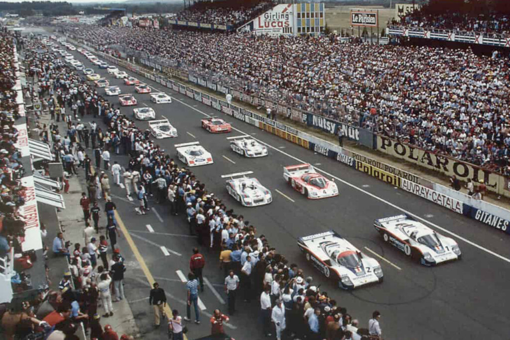 Rows of race cars lined up at the start point during a 24 hours of Le Mans race.