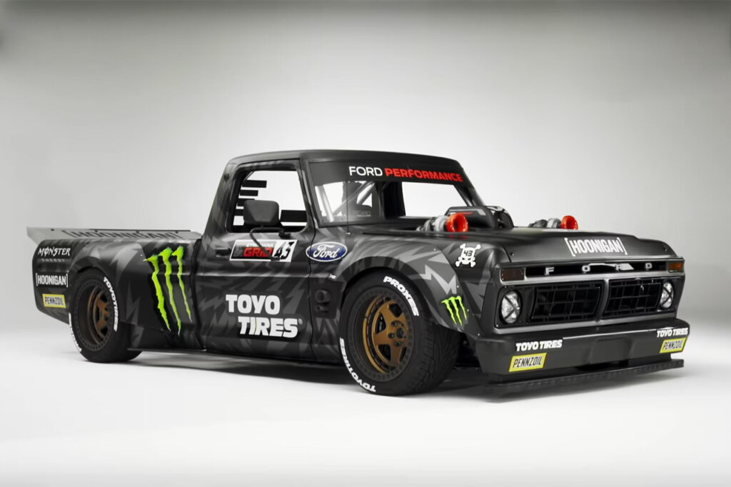 Black Hoonitruck F150 parked in a white stage with black gradient at the top of the frame.