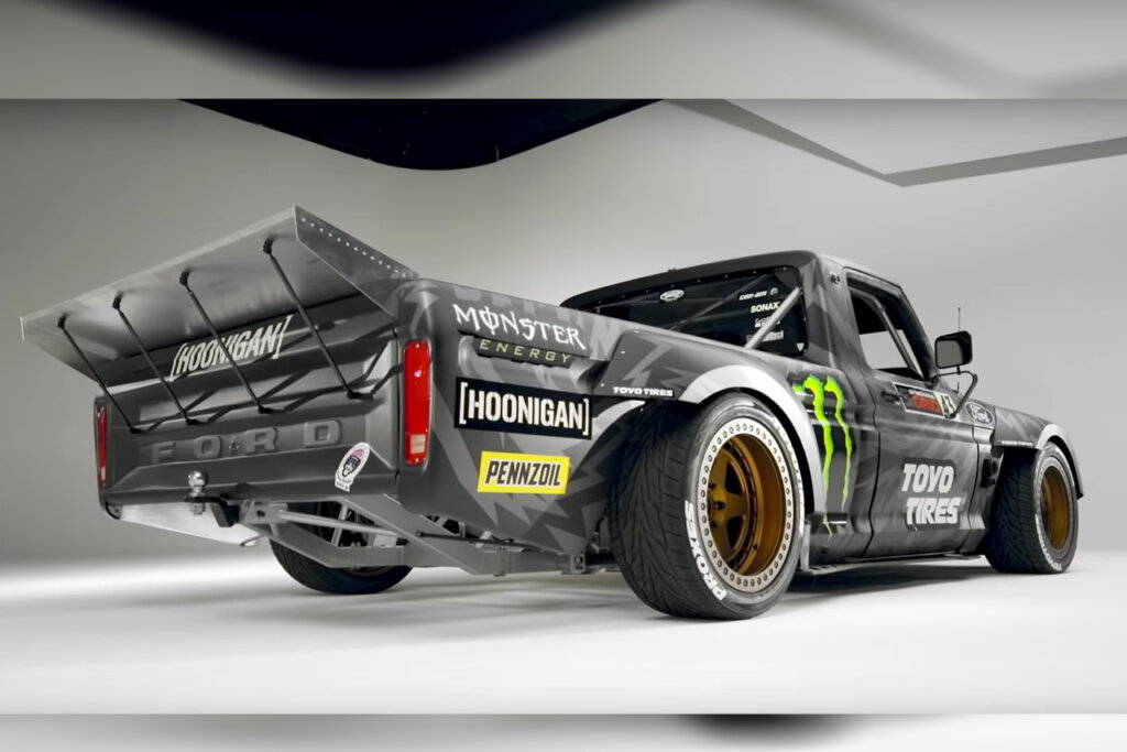 Black Hoonitruck F150 parked at an angle in a room with white backdrops showing underside of the truck.