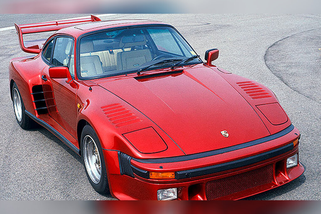 Red Porsche 911 930 parked on a street.