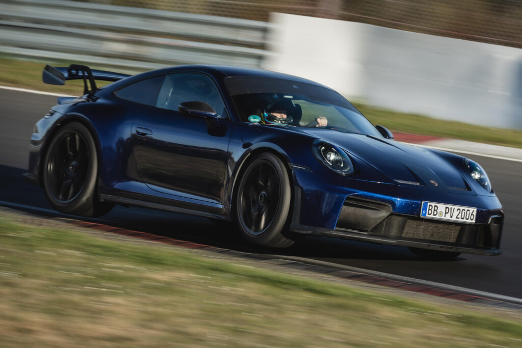 Blue porsche 911 GT3 racing at the Nordschleife