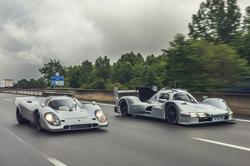 Silver Porsche 963 RSP and Count Rossi Porsche 917K on a highway