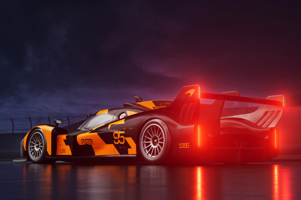 rear of Orange and black McLaren LMDh Hypercar