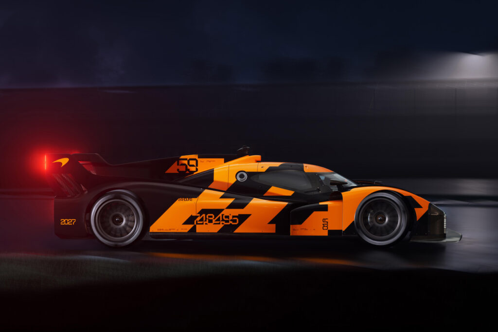 side view of Orange and black McLaren LMDh Hypercar