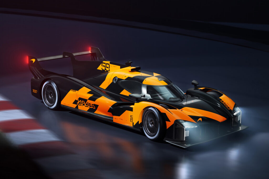 Orange and black McLaren LMDh Hypercar on a race track