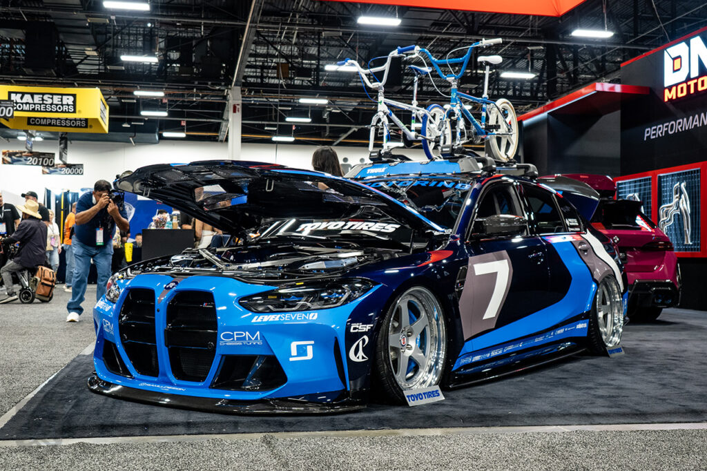 blue bmw m3 g80 in the dNA motoring booth 20329 at sema 2025