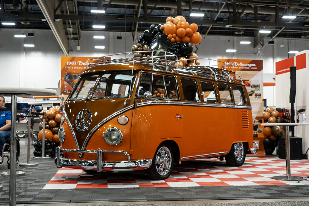fluffyguy orange 1967 volkswagen type 2 deluxe 21-window samba in Jay Lenos Garage booth 24559 at sema 2025