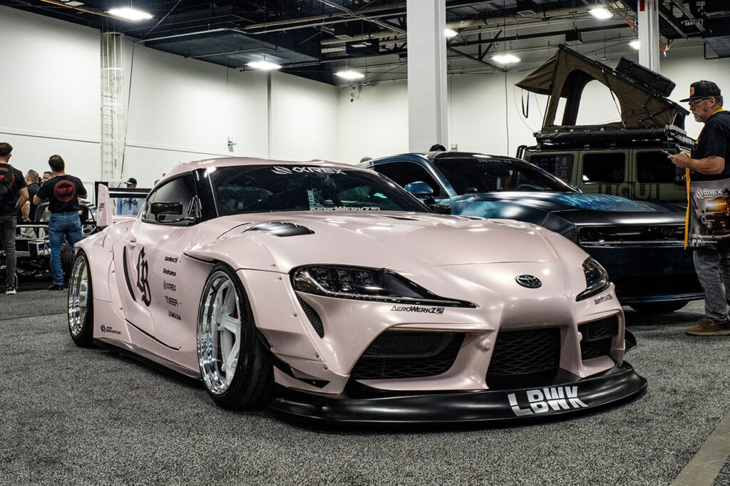 s2lindos pink libertywalk toyota supra mk5 in central hall at SEMA 2025