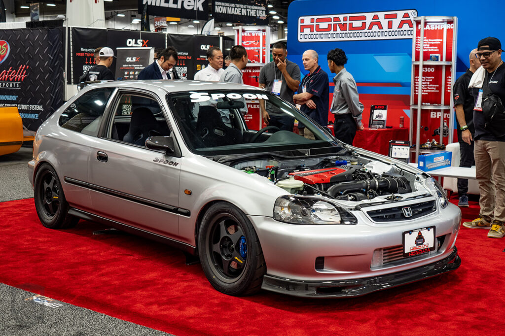 silver honda civic hatchback EK with k20c engine swap in hondata inc booth at sema 2025 central booth