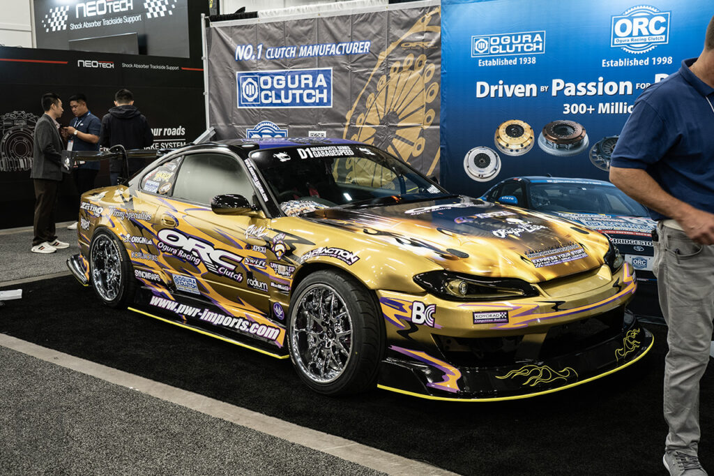 gold ps13chval nissan s15 in ogura racing clutch booth at 2025 sema central hall