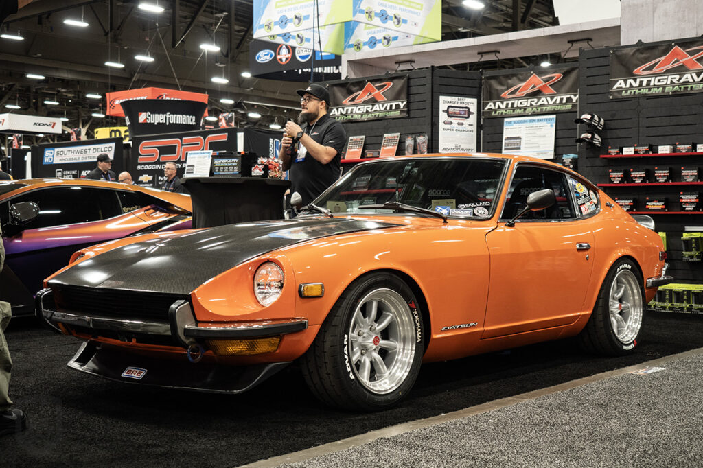 orange larry_chen_foto datsun 240z in the antigravity batteries booth at sema 2025 central hall