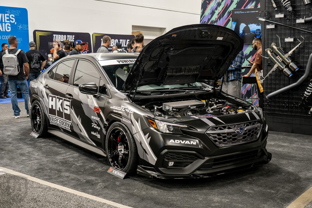 black subaru wrx in HKS booth at sema 2025 central booth