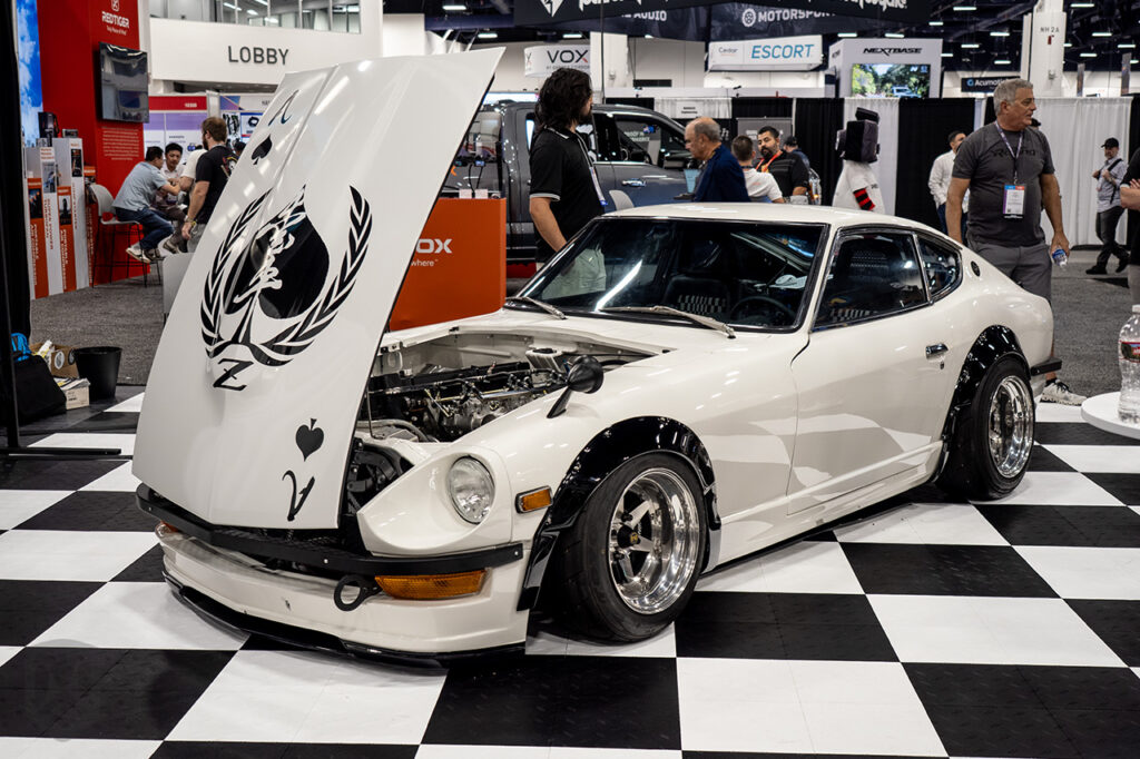 white datsun 240z resto mod built by Aisha LLC in the Soul Interface In-Car AI booth 10115 at sema 2025 north hall