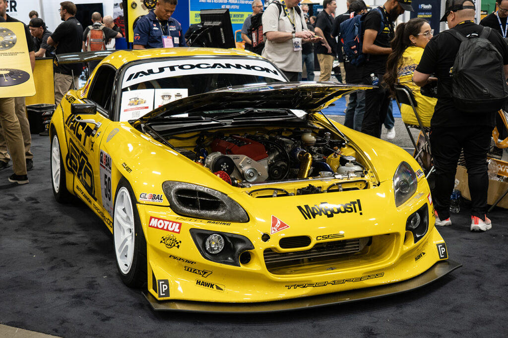denniscaco yellow honda s2000 in the act booth 23031 at sema 2025