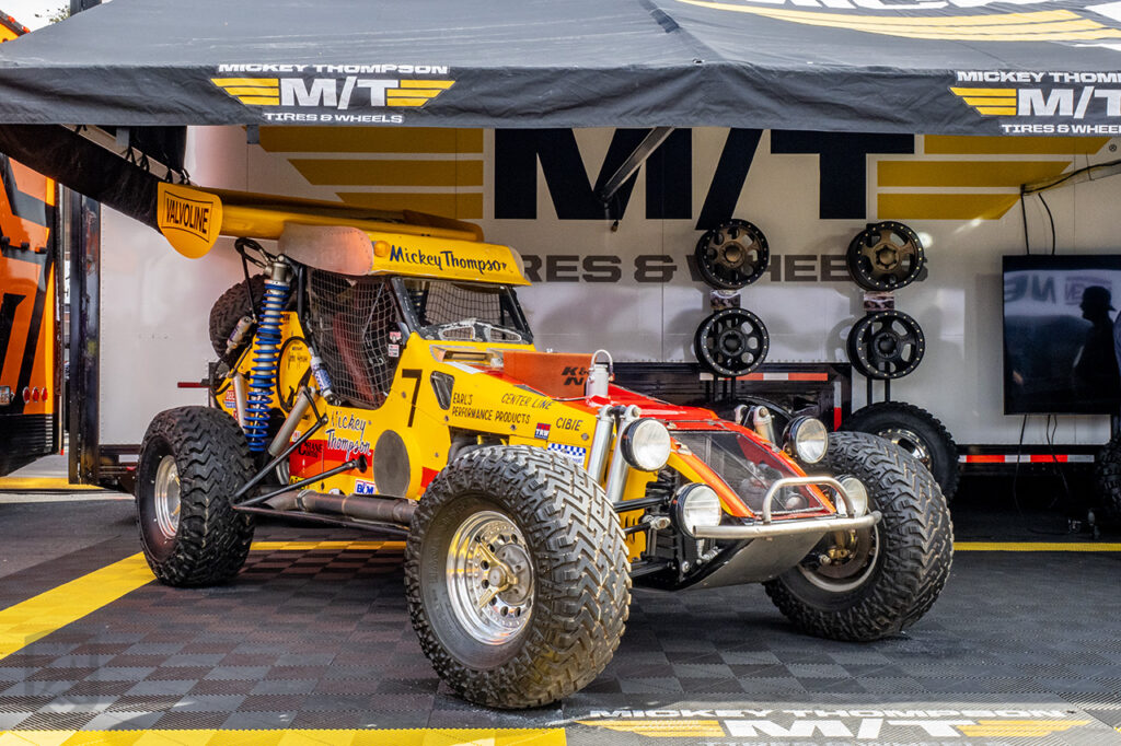 Mickey thompson's yellow off-road race car at the mickey thompson booth #84180 at sema 2025