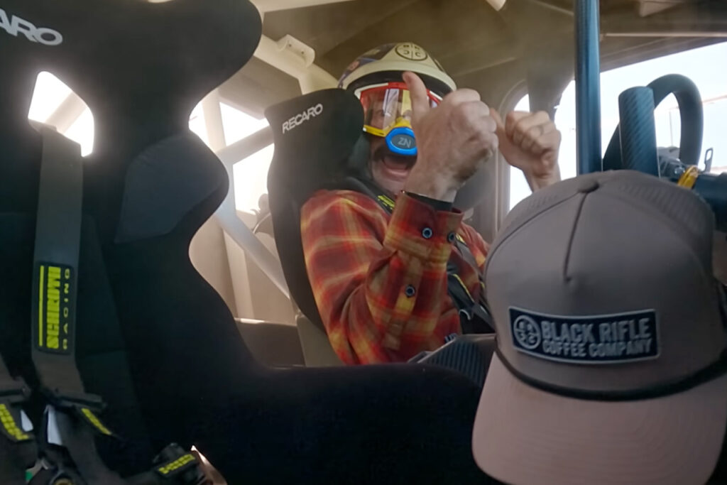 travis pastrana giving a thumbs up mid air in the hoonigan subarau brataroo 9500 Turbo