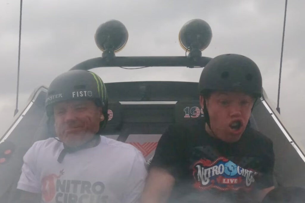 2 guys in the backseat of the hoonigan subarau brataroo 9500 Turbo